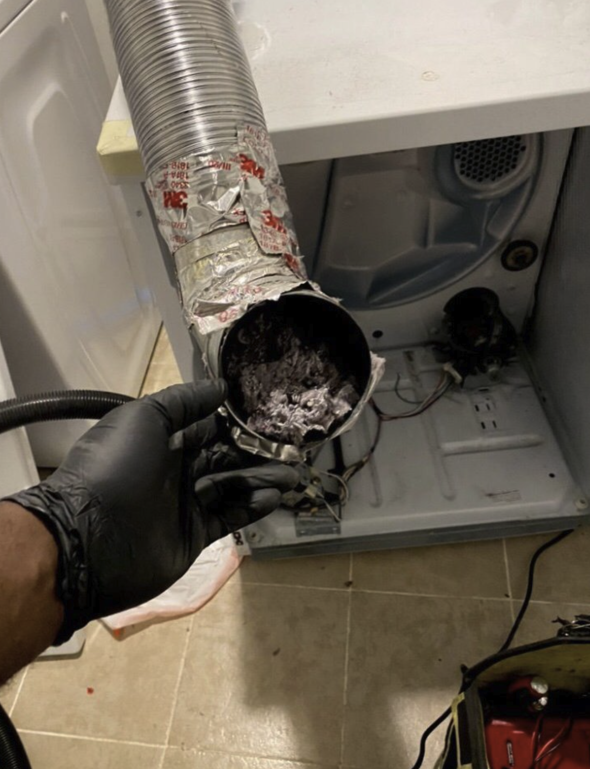 Dryer vent service and lint duct cleaning — clogged transition hose removed for service